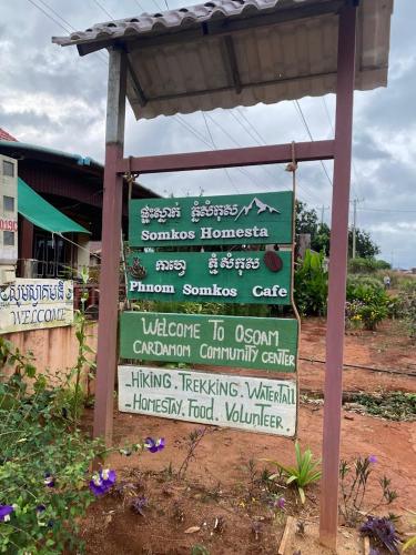 a sign with many different signs on it at Cardamom Community Center in Moăt Preăh