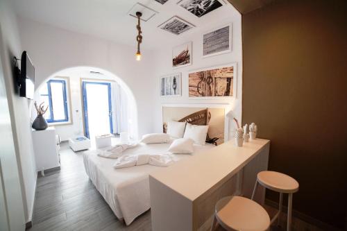 
a dining room with a white table and chairs at Kaerati Apartments in Katapola
