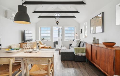 a kitchen and living room with a table and a couch at Amazing Home In Otterup in Otterup