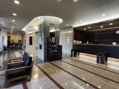 a lobby of a fashion store with a chair at Hotel Route-Inn Yamagata Ekimae in Yamagata