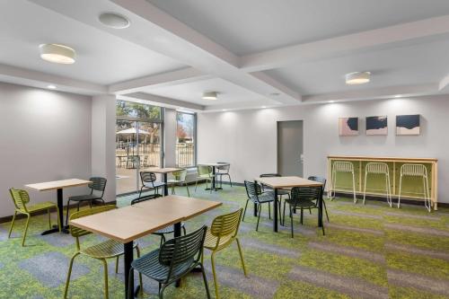 a room with tables and chairs in a building at Spark by Hilton Richardson Dallas in Richardson