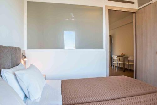 a bedroom with a bed and a dining room at Gerona Mare Apartments in Gerani Chanion