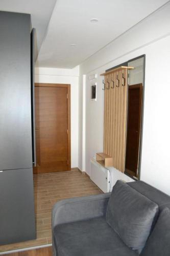 a living room with a couch and a mirror at A 14 President Kopaonik in Raška