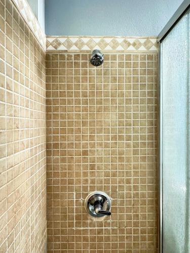a shower with a shower head in a bathroom at Modern & Spacious Family and Friend 4B3B House in Moreno Valley