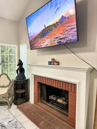 a fireplace with a flat screen tv above it at Modern & Spacious Family and Friend 4B3B House in Moreno Valley
