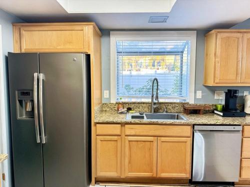 a kitchen with a stainless steel refrigerator and a window at Modern & Spacious Family and Friend 4B3B House in Moreno Valley