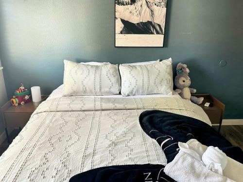 a bedroom with a bed with a teddy bear on it at Modern & Spacious Family and Friend 4B3B House in Moreno Valley