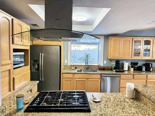 a kitchen with a stove top oven in a kitchen at Modern & Spacious Family and Friend 4B3B House in Moreno Valley