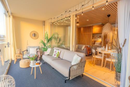a living room with a couch and a table at Marina Resort Apartments by Hiekka Booking in Kalajoki