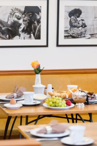 a table with plates of food on top of it at Hotel Am Helmwartsturm in Andernach