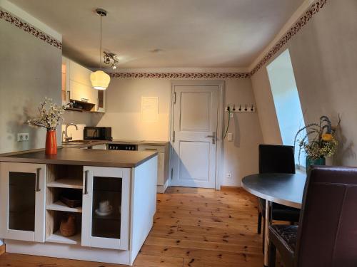 a kitchen and dining room with a table and a counter at Grafschaft in Jüterbog