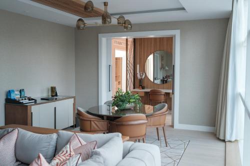 a living room with a couch and a table at The Lowry Hotel Manchester in Manchester