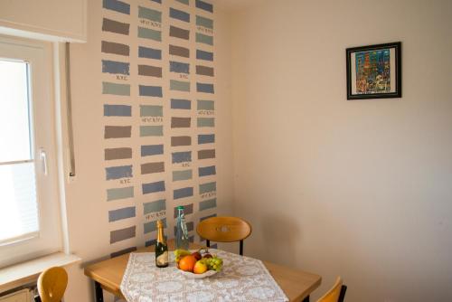 a dining room table with a bowl of fruit on it at Haus Sigge Ferienwohnungen in Bad Sassendorf