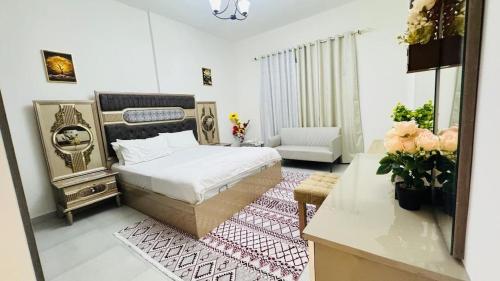 a bedroom with a bed and a living room at Spacious & Stylish 3-Bedroom Home in a Prime Location in Dubai