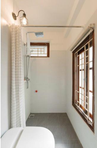 a bathroom with a toilet and a window at Humi Hotel in Hanoi