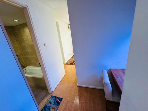 a small bathroom with a shower and a tub at Soha Homestay in Kuala Lumpur