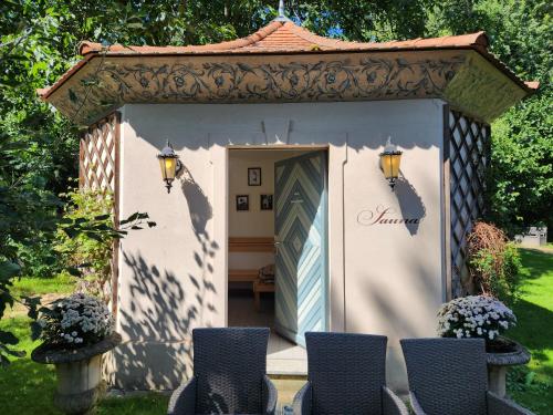 a gazebo with a door in a yard at Grafschaft in Jüterbog