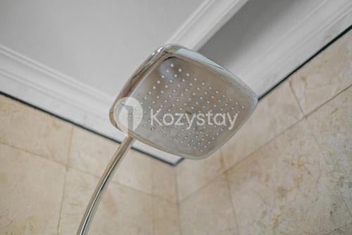a chair in a shower in a bathroom at Camila by Kozystay - Kuningan in Jakarta