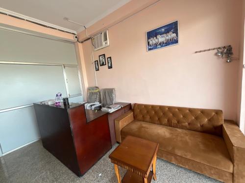 a living room with a couch and a table at Hotel the desert inn in Jaipur