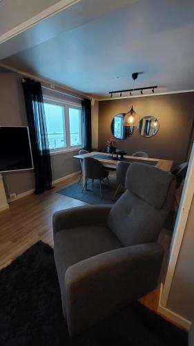 a living room with a couch and a table at Lyngen Apartments in Lyngseidet