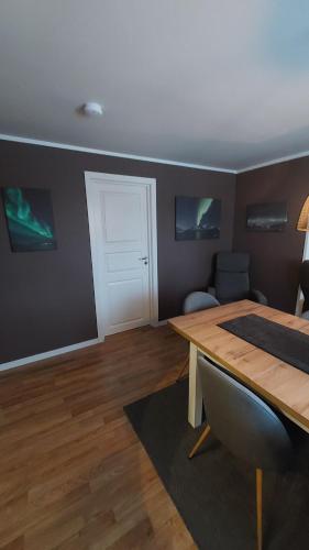 a room with a table and a white door at Lyngen Apartments in Lyngseidet