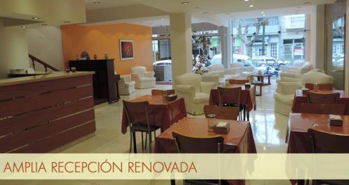 a restaurant with tables and chairs in a building at BALOO Hotel in Mar del Plata