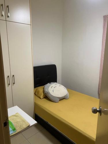 a small room with a bed and a cabinet at Connaught Avenue in Kuala Lumpur