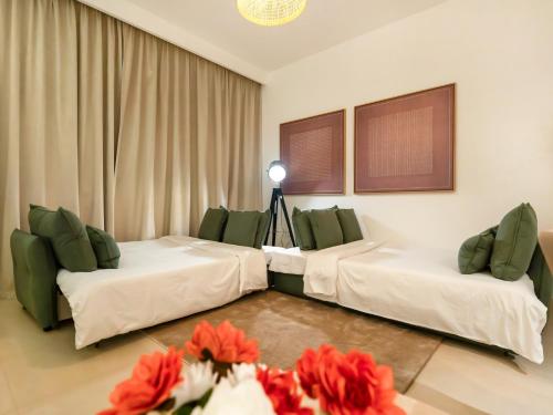 a hotel room with two beds and a camera at Royal Vista at Downtown Views II - Downtown Dubai City Views - Brand New Luxury 2BR Apartment in Dubai