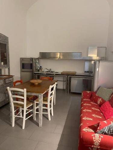 a kitchen with a table and a couch in a room at Casa Felice Apartment in Orvieto