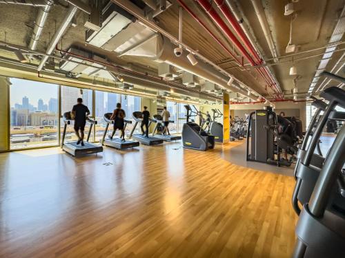a group of people doing pilates in a gym at Royal Vista at Downtown Views II - Downtown Dubai City Views - Brand New Luxury 2BR Apartment in Dubai