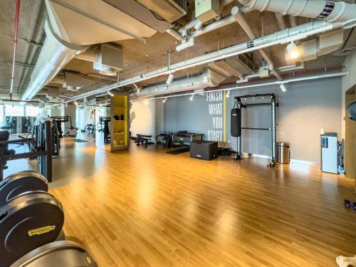 an empty gym with a hard wood floor and equipment at Royal Vista at Downtown Views II - Downtown Dubai City Views - Brand New Luxury 2BR Apartment in Dubai