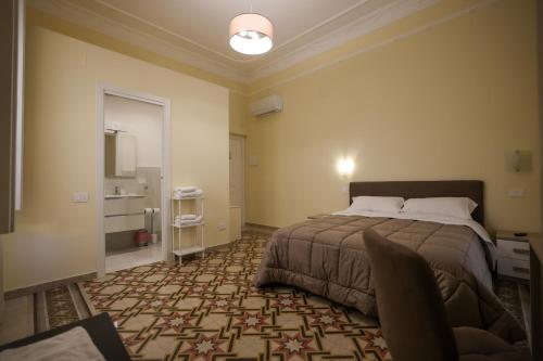 a bedroom with a large bed and a bathroom at B&B Salerno Stay in Salerno