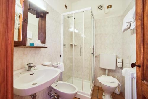 a bathroom with a sink and a toilet and a shower at Agriturismo Palazzo Bandino - Wine cellar, on reservation restaurant and spa in Chianciano Terme