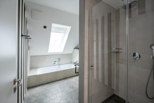 a bathroom with a shower and a bath tub at 4Hafenzeiten - NIE11 Hamburg in Niendorf