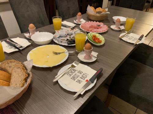 a table with breakfast foods and drinks on it at Gasthof Knezevic in Leoben