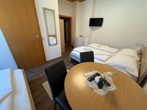 a hotel room with a table and a bed at Gasthof Knezevic in Leoben