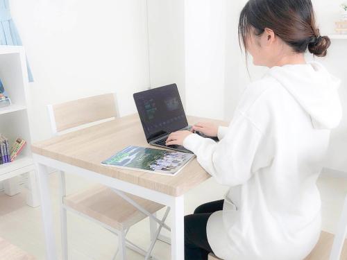 a woman sitting at a table with a laptop computer at Guest House Isehutami - Vacation STAY 89326v in Ise