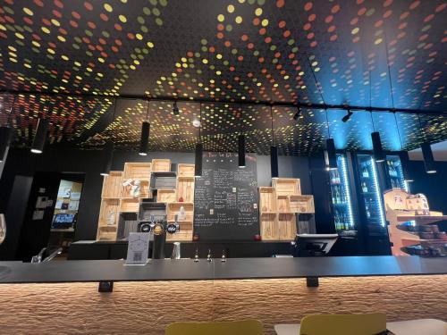 a display case in a restaurant with wooden boxes at ibis Strasbourg Sud La Vigie in Ostwald
