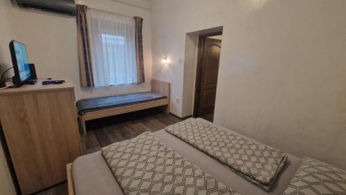 a bedroom with a bed and a window and a bench at Bem Downtown Apartment in Debrecen