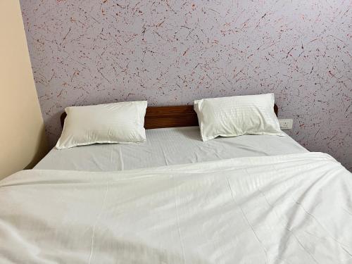a bed with two white pillows on top of it at Hotel the desert inn in Jaipur