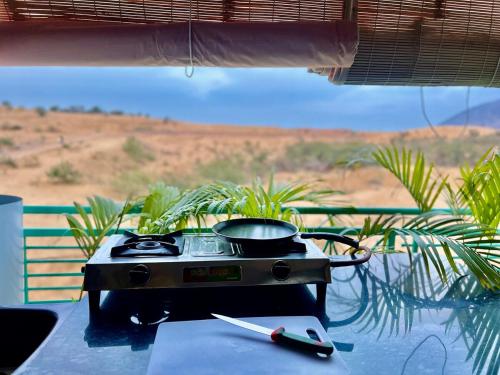 a grill sitting on a table with a pan on it at Pushkar Story in Pushkar