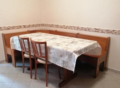 a dining room table with chairs and a white table cloth at Ronf & Gnam GALIMBERTI in Turin