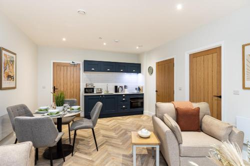 a living room with a couch and a table at Rock Mill 1 Bed Apartment 4 in Stoney Middleton