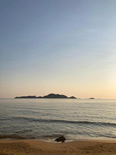 a beach with an island in the water at Kokkini Peach Budget in Kokkínion