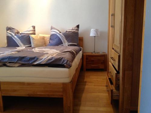 a bedroom with a bed with blue sheets and pillows at Haus Ferdinand in Fernitz