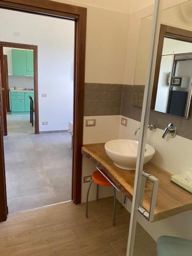a bathroom with a sink and a mirror at Agriturismo Palazzo Bandino - Wine cellar, on reservation restaurant and spa in Chianciano Terme