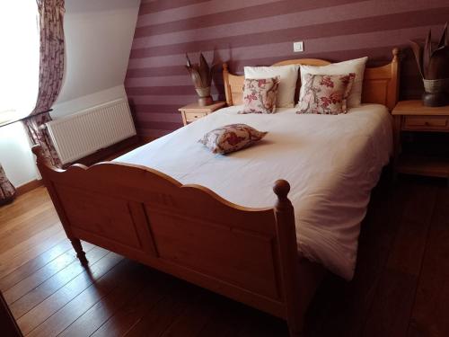 a large bed with a stuffed animal on it at Château-ferme de Pondrome in Beauraing