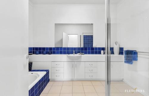 a bathroom with a tub and a sink and a shower at Seaview on The Esplanade in Portarlington