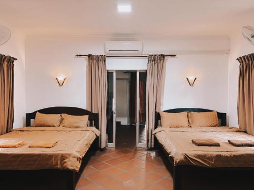 Ένα ή περισσότερα κρεβάτια σε δωμάτιο στο Coconut Village Guesthouse and Bungalow
