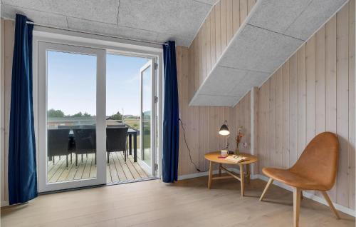 a room with a sliding glass door and a table and a piano at Lovely Home In Thisted in Thisted